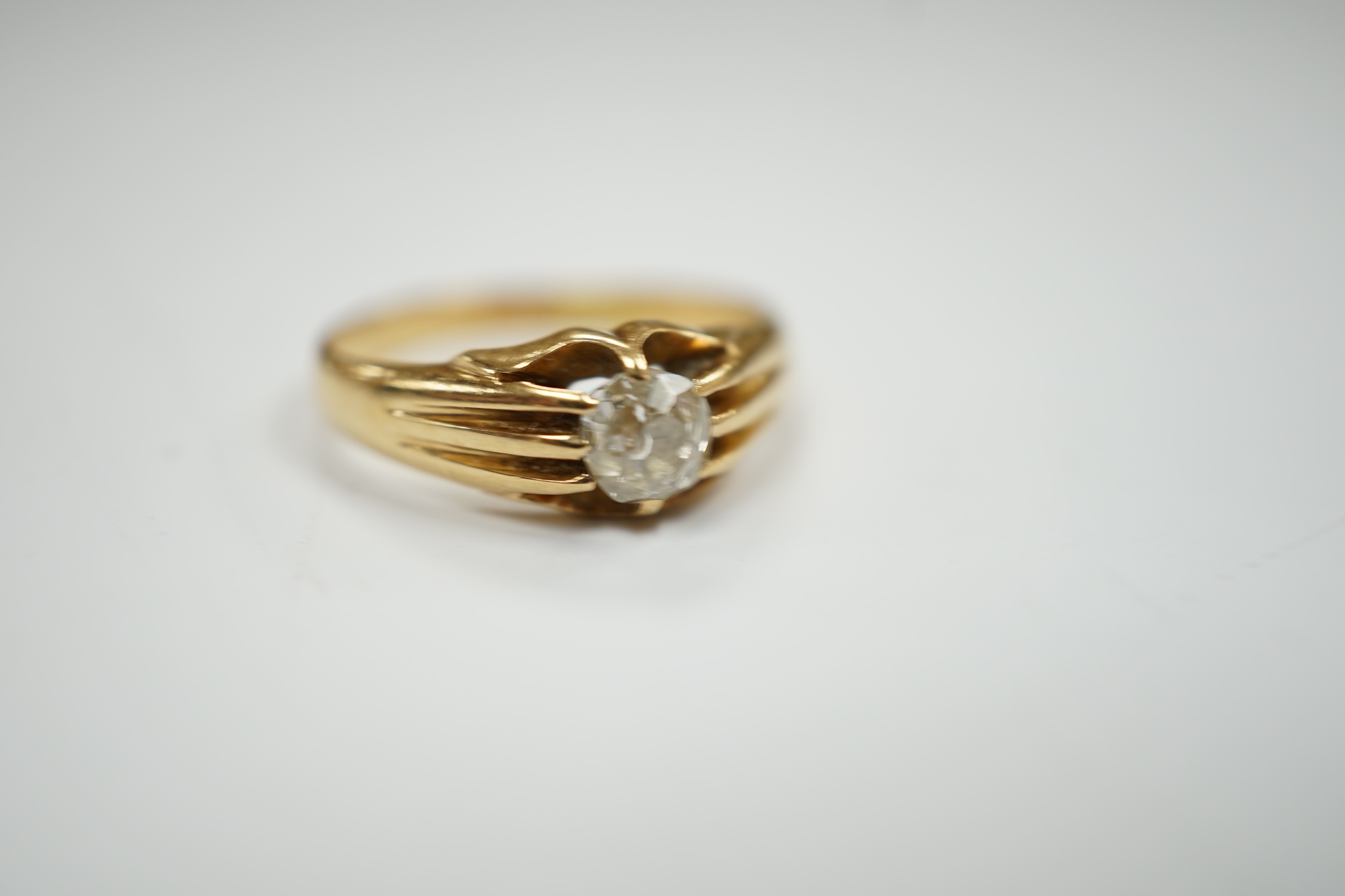 An 18ct gold and claw set solitaire diamond ring, size L, gross weight 3.5 grams.